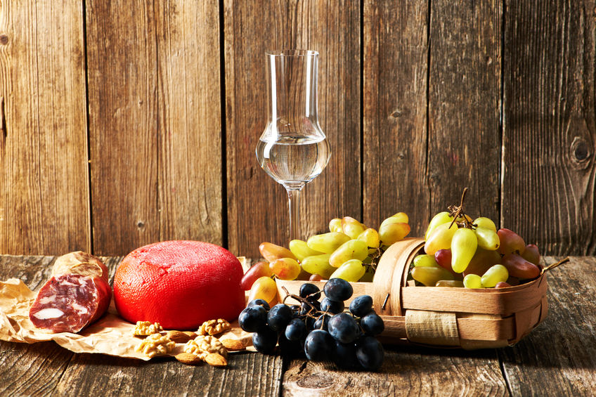 Fresh grapes, grappa and cheese on old wooden table - Copyright: ClipDealer - haveseen